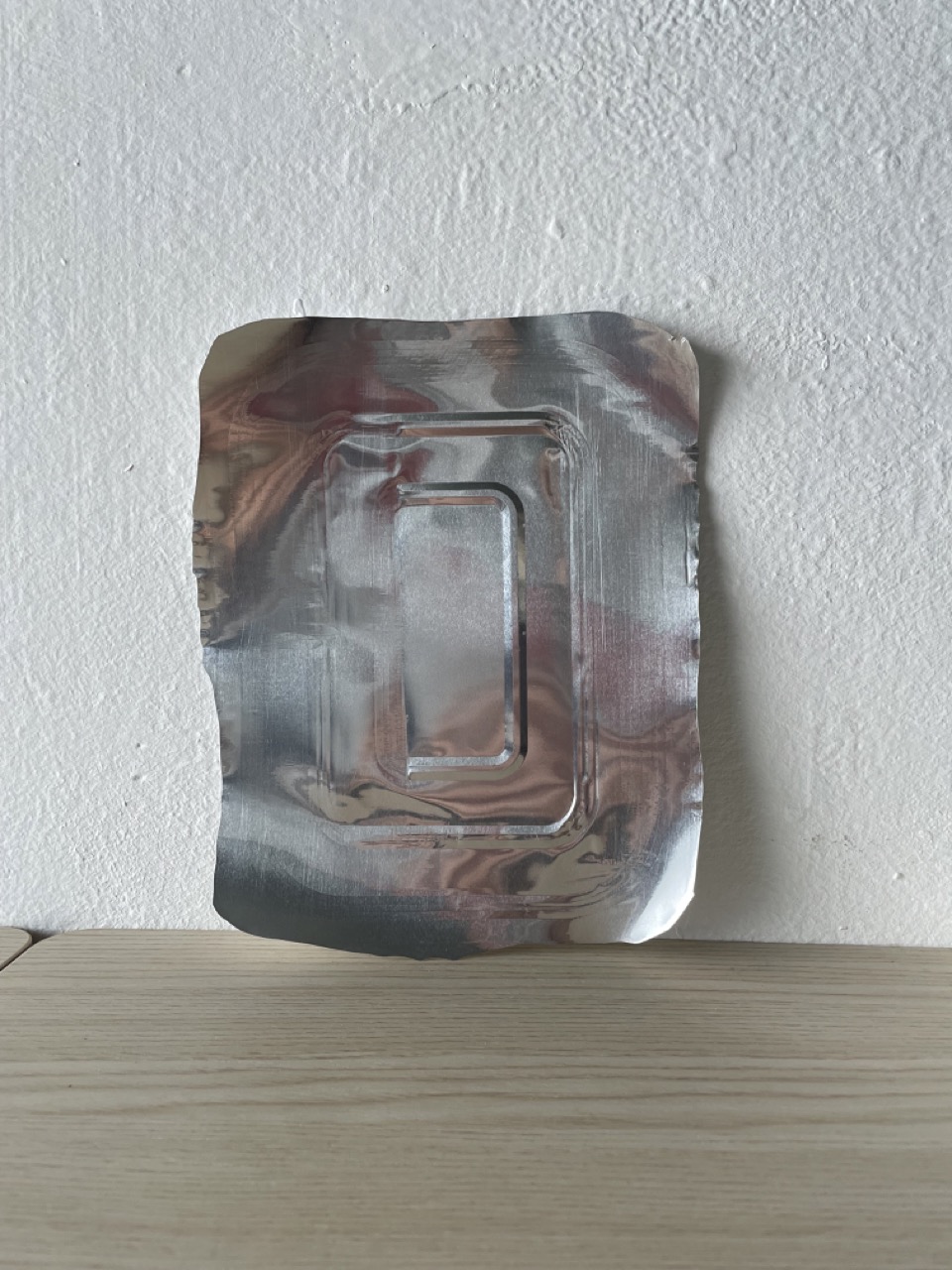 Flat aluminium piece cut from tray